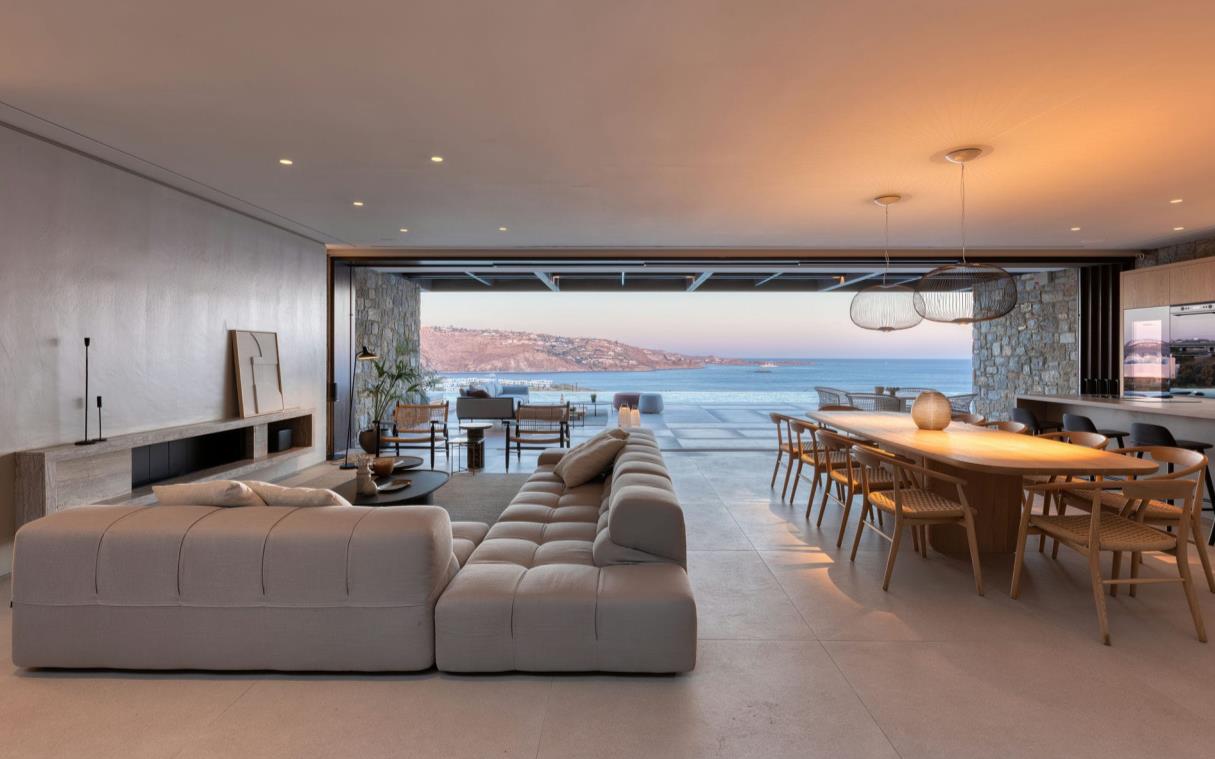 Open-plan lounge and dining room with sunset views