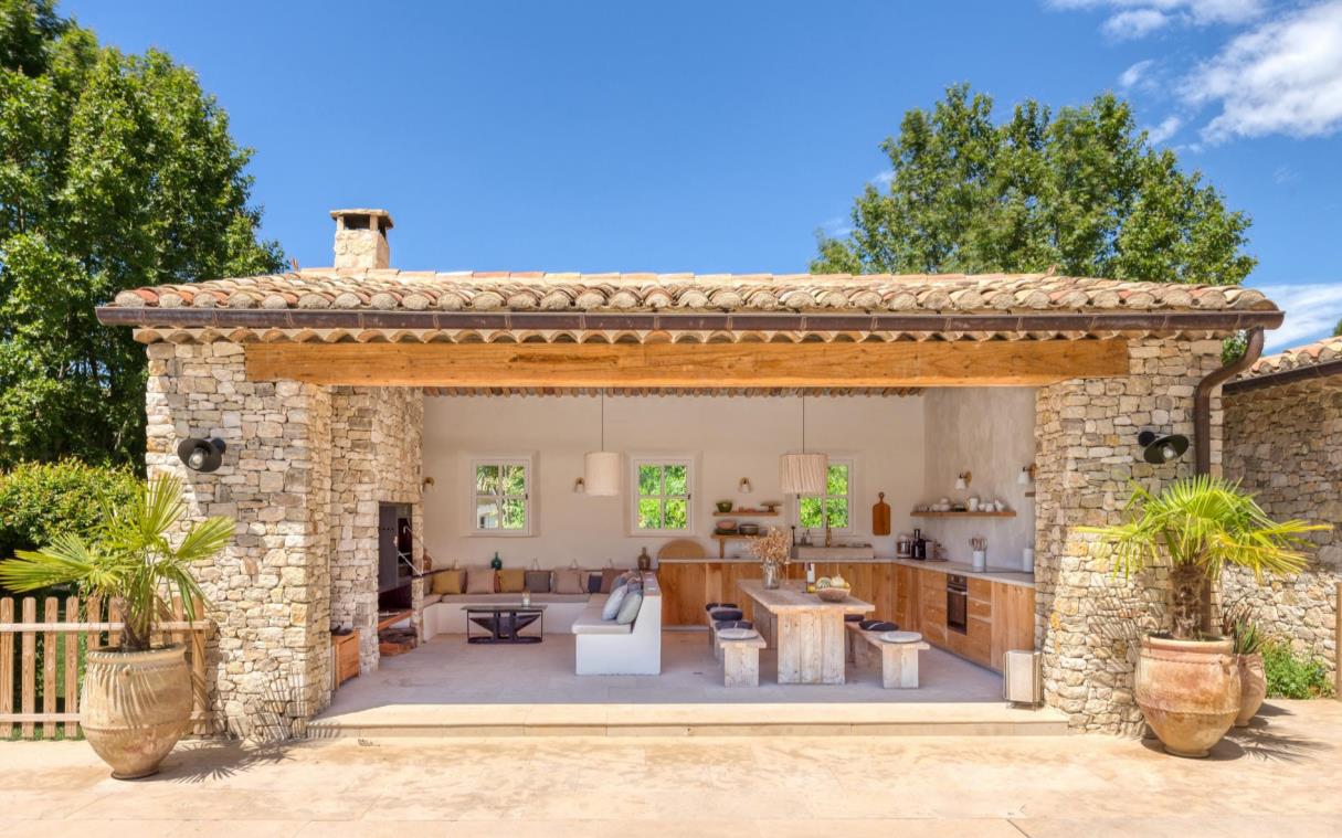 Pool house with living area, dining table and full kitchen