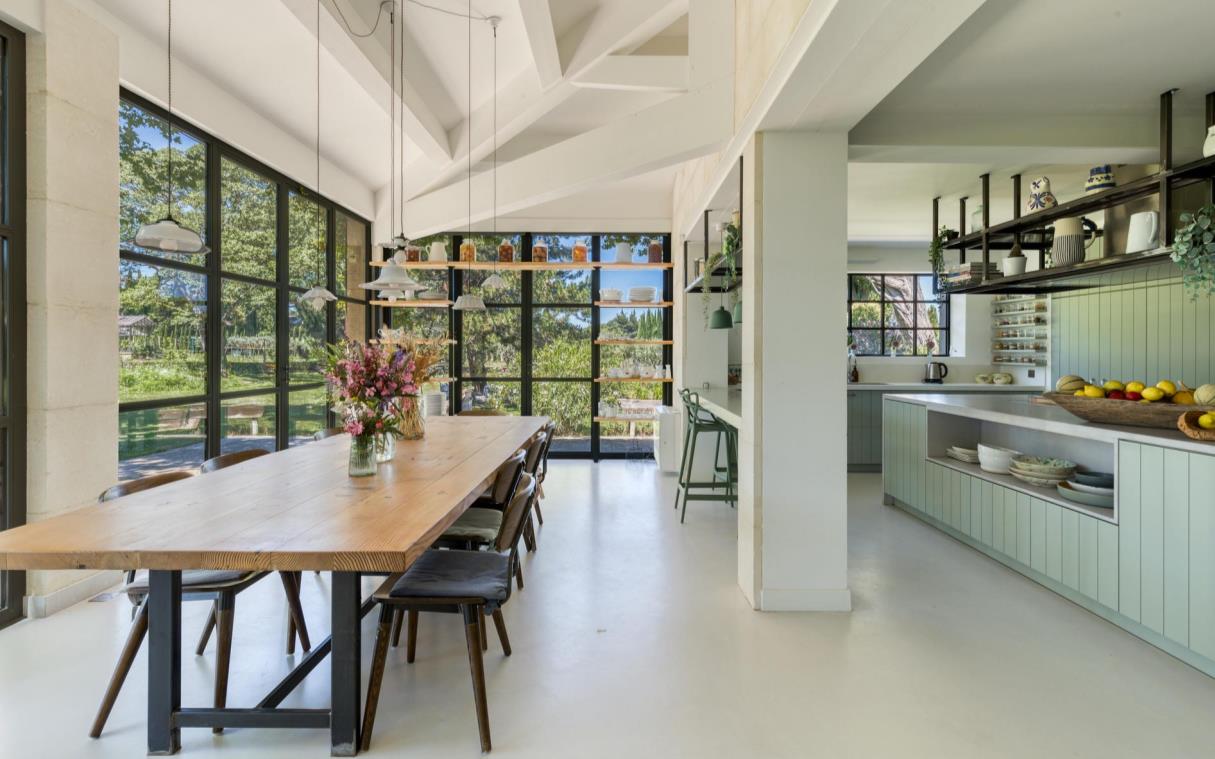 Country-style kitchen and dining area with glass walls